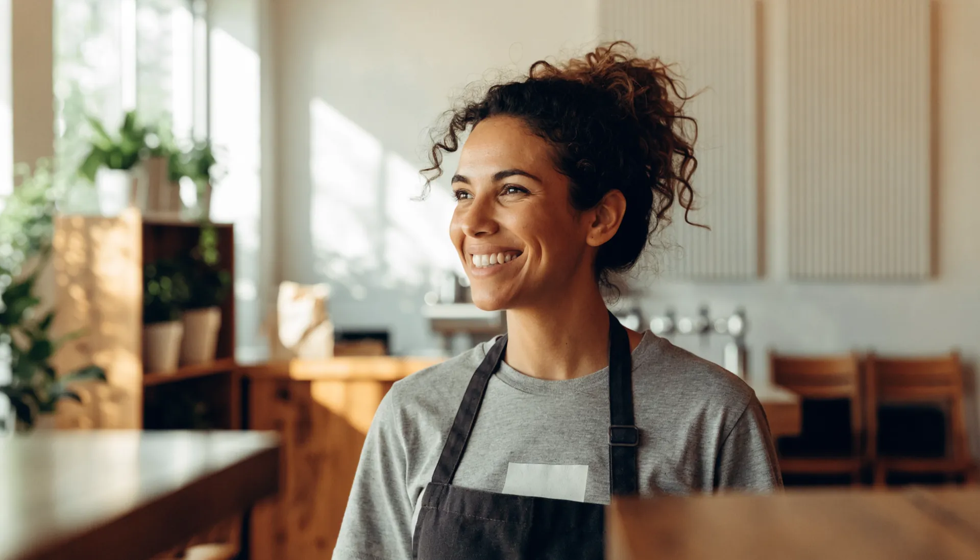 A coffee shop owner wearing her shop’s shirt